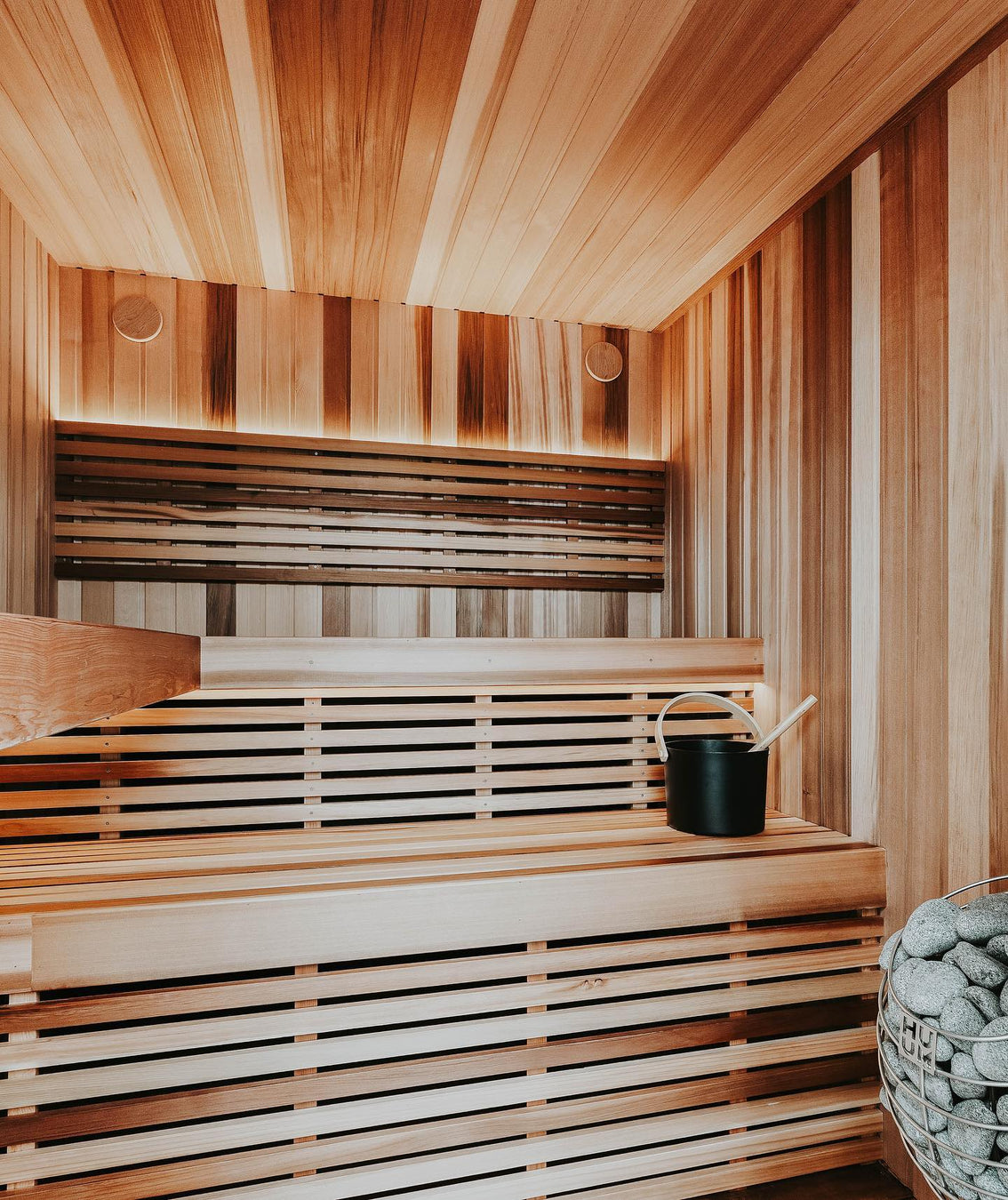 Custom Sauna With Multicolored Vertical Cladding and HUUM Drop Heater