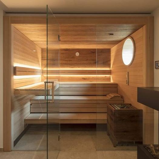 Custom Sauna With Round Window and Glass Front and 2 Tier Benches and Floating Side Bench