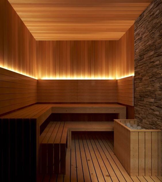 Custom Sauna With Stone Feature Wall and Upwards Wall Lighting