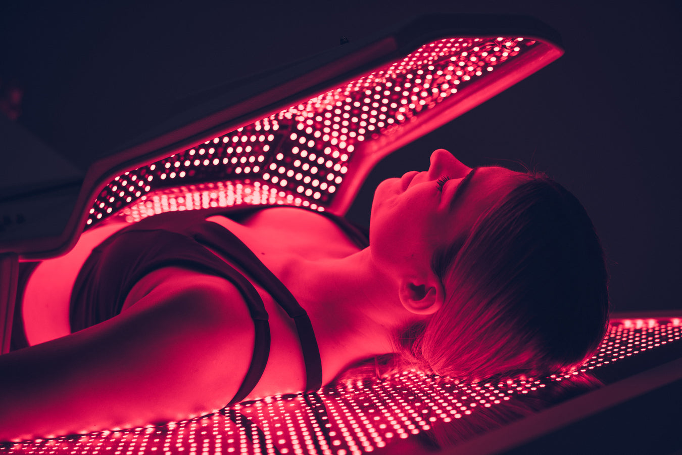 Female Laying in Red Light Therapy Bed